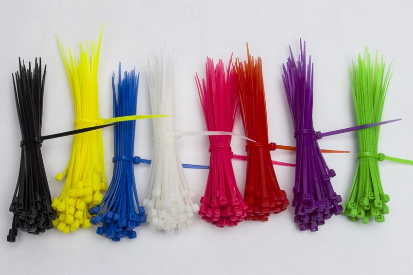 Multi-color nylon cable ties in black, yellow, blue, white, pink, red, purple, and green for cable management and wire organization in industrial and electrical applications.