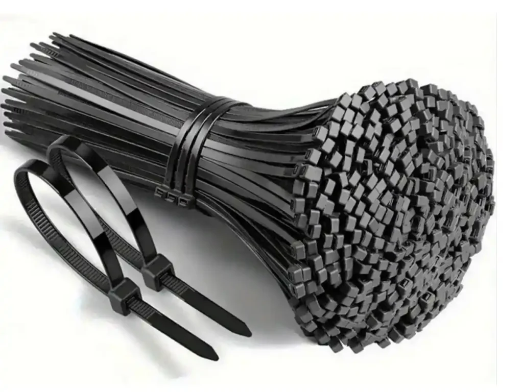 Bundle of black nylon cable ties (zip ties) with self-locking fasteners, displayed on a white background for cable management, wire organization, and general fastening applications